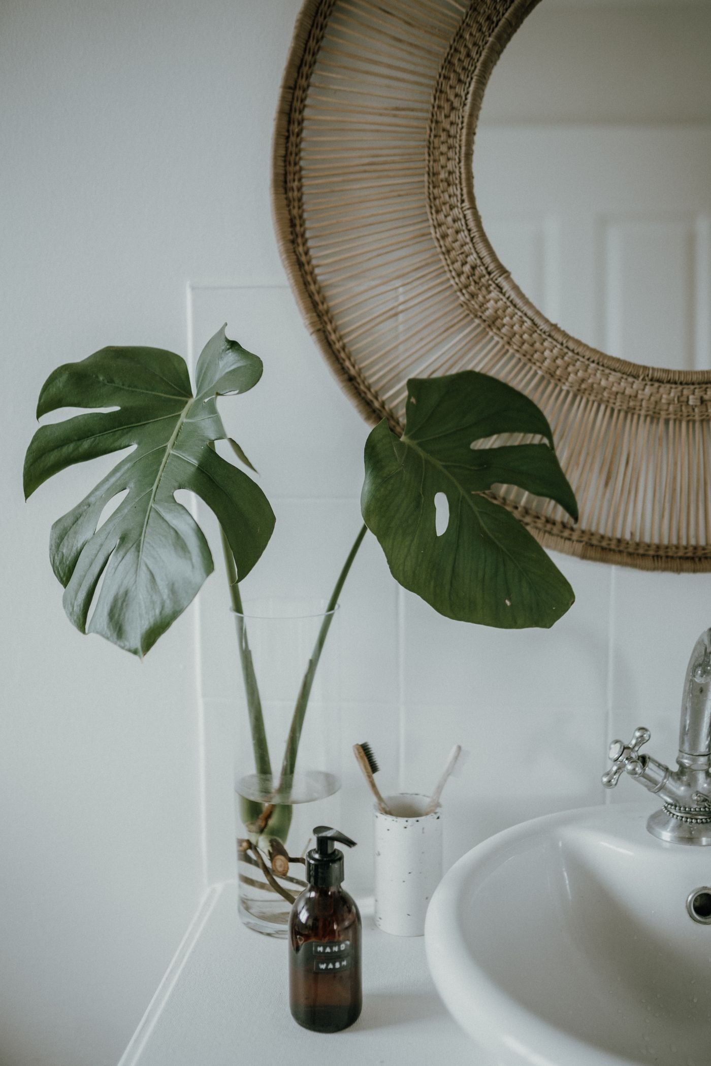 Boho bathroom with a rattan mirror