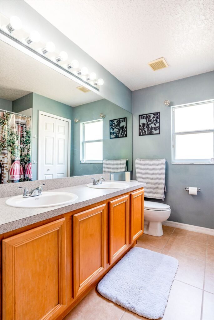 Bathroom with large mirror and wood cabinets