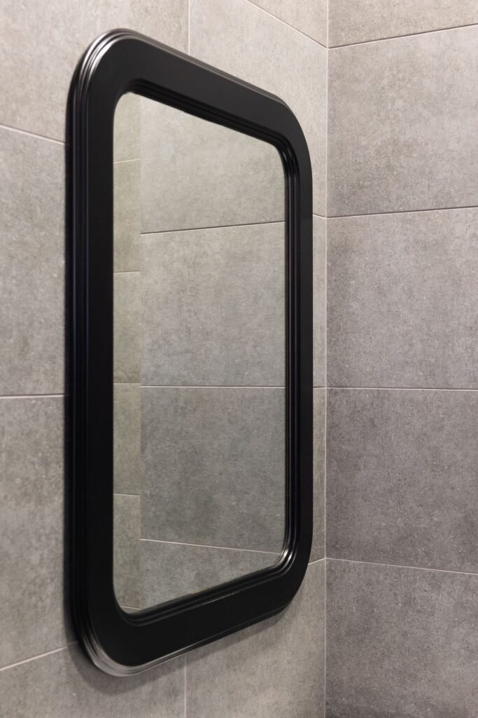 Bathroom with wooden framed mirror