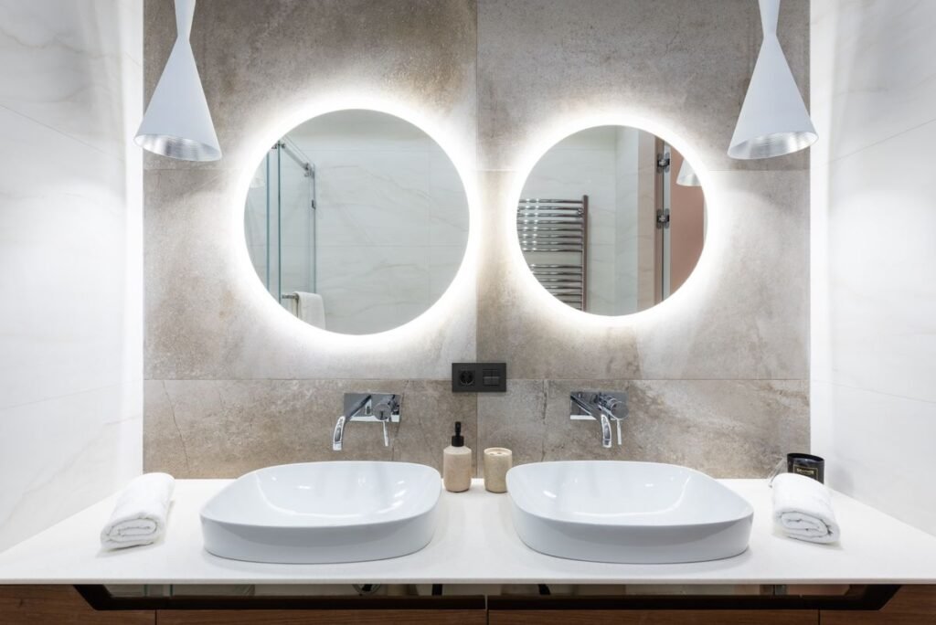 Bathroom with round backlit mirrors